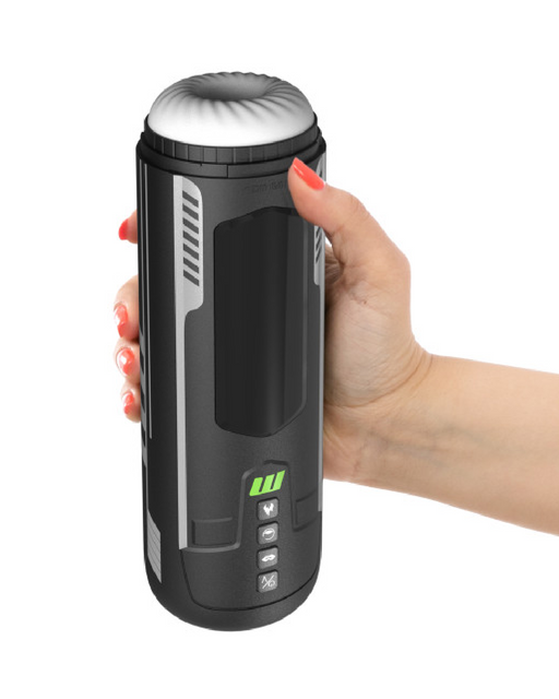 A person with red nail polish holds a sleek, black cylindrical gadget with a metallic top. The device, the Blush Master Blaster Vibrating, Stroking, Sucking, Warming, Automatic Stroker, features several buttons and lights on its front, suggesting functionality. The hand is positioned on the right side, gripping the device firmly, highlighting its advanced suction technology.