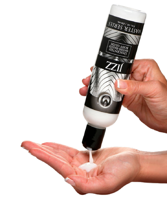 A person is squeezing a bottle of a product labeled "Jizz Ultra Realistic Unscented Lube 8.5oz" and "XR Brands" onto their palm. The water-based lubricant appears to be a lotion or similar liquid substance, and the bottle has a black-and-white design, making it both sex toy compatible and versatile for various uses.