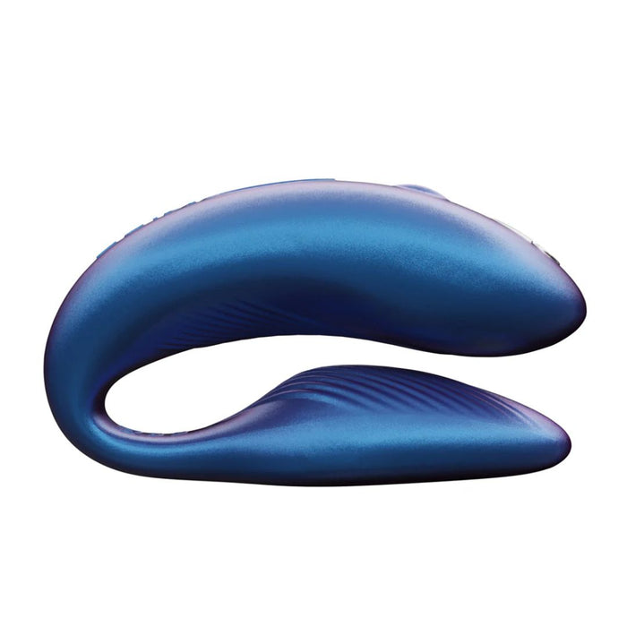 The We-Vibe Chorus Remote & App Controlled Couples' Vibrator in blue, from the renowned brand We-Vibe, is a sleek and curved electronic device with a futuristic design, mimicking a flexible U-shape. This adjustable vibrator boasts smooth metallic surfaces and touch-sensitive vibrations, making it ideal for couples in search of an innovative experience.