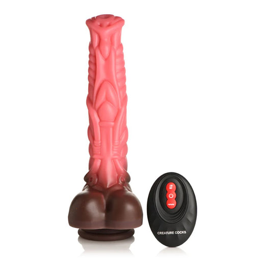 A textured, pink and brown Deluxe Centaur 10 inch Vibrating & Thrusting Silicone Fantasy Horse Dildo from XR Brands stands upright next to a black, oval-shaped remote control. The remote has a red button and additional control buttons, with the text "CREATURE COCKS" printed below them. This unique piece includes realistic thrusting vibration for an enhanced experience.