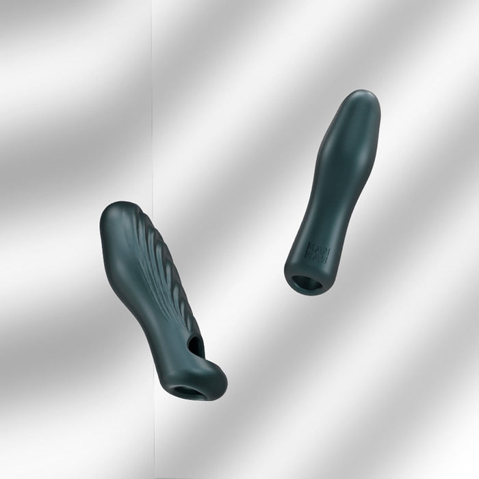 Two dark green, elongated Ryzer 2 in 1 Penis Extenders and Masturbation Sleeves with textured silicone designs are shown against a light, softly blurred background. They seem to be made of a soft material with contoured designs.