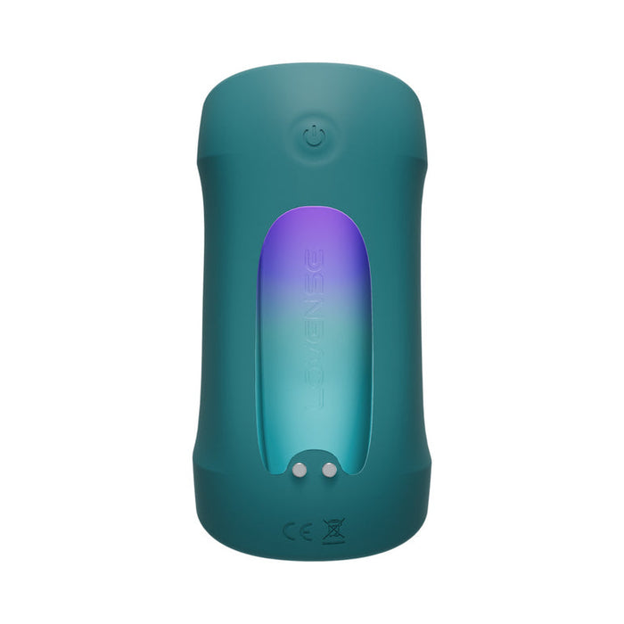 A teal, cylindrical electronic device operates hands-free with a power button on top and a display of purple-to-blue lights. It features symbols and "Lovense" on the front, compatible with the Lovense app for easy control. Product: Lovense Gush 2 Hands-Free Oscillating Masturbator with App.