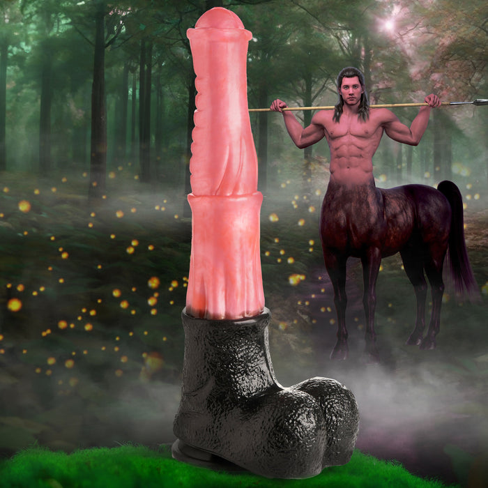 The surreal image showcases a giant humanoid finger with a grotesque face, adorned in black shoes, prominently placed in the foreground. In the background, a muscular centaur stands in a misty forest, brandishing an XR Brands Centaur Giant 13 Inch Silicone Fantasy Horse Dildo horizontally across his shoulders. Glowing orbs float throughout the scene.