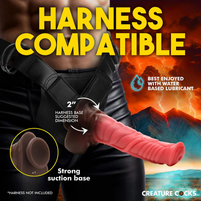 A person wearing a black harness with a realistically designed red and brown phallic attachment. The text reads "Harness Compatible" and "Best enjoyed with water-based lubricant." It highlights features like "2” harness base suggested dimension," “Strong suction cup base," and “thrusting vibration.” The brand name "XR Brands" is displayed at the bottom. In the background, a fiery landscape provides an intense backdrop for the Deluxe Centaur 10 inch Vibrating & Thrusting Silicone Fantasy Horse Dildo.