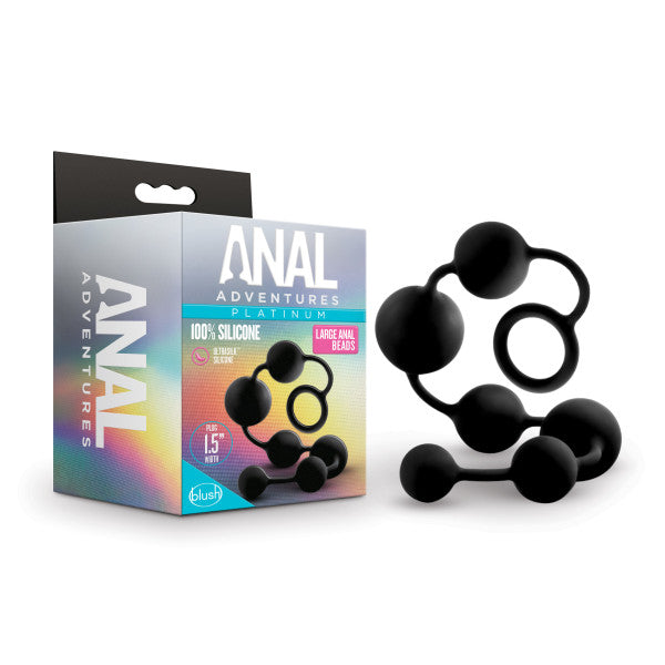 A product image of "Anal Adventures Silicone Large Anal Beads" by Blush. The box displays the product name and details about the 100% silicone material. In front of the box, there is a silicone sex toy featuring large black graduated anal beads with a loop handle for easy use.