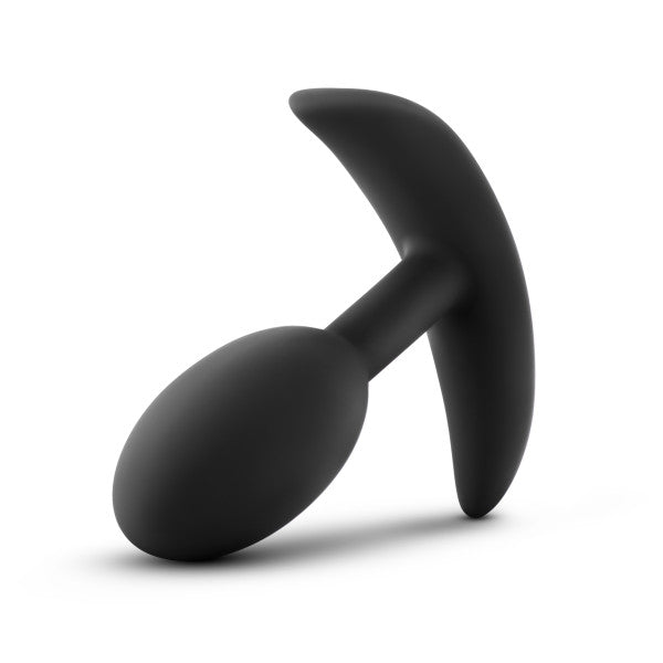 **Blush Anal Adventures Slim Vibra Weighted Plug - Small**: A black anal plug made from body-safe silicone, featuring a teardrop-shaped body and a curved, handle-like base on a white background. Designed for personal use and slightly tilted, this plug offers inner weight stimulation for enhanced pleasure.