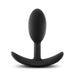 The Anal Adventures Slim Vibra Weighted Plug - Small by Blush is a black silicone butt plug featuring a smooth, tapered, and rounded insertable head made of body-safe silicone. It also has a flared base ergonomically designed for comfort and safety during use, making it an ideal plug for long-term wear.