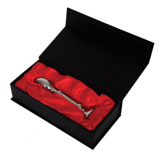 An Aneros Tempo Stainless Steel Anal Stimulator is elegantly displayed in a black presentation box lined with red satin fabric, highlighting the product's shine and design.