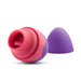 The Blush Aria Flutter Tongue Clitoral Licking Oral Sex Vibrator, designed for clitoral stimulation, showcases a vibrant pink and purple color scheme. It features a cup-like opening at one end and offers 7 vibration modes, complemented by a removable purple cap placed beside it.