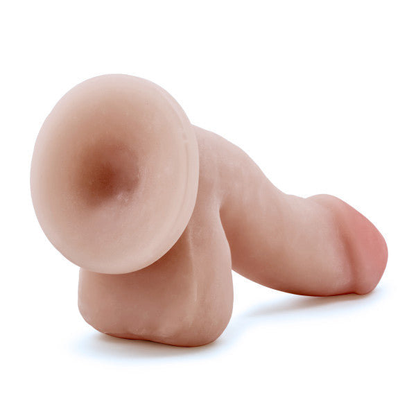 The Au Naturel 6.5 Inch Dual Density Suction Cup Dildo - Vanilla by Blush is a realistic, flesh-colored silicone dildo that features detailed characteristics including a sturdy suction cup base for hands-free play, and stands upright at an angle. Made with Dual Density Sensa Feel material, it is soft and flexible, designed to provide a lifelike look and feel.