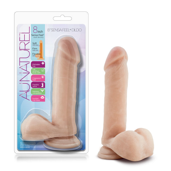 A packaged and unpackaged 8-inch realistic dildo from Blush's 'Au Naturel' collection, featuring a suction base. The vanilla dildo boasts a soft, flesh-toned appearance with packaging that highlights its softness, firmness, flexibility, and body-safe materials. Officially named the "Au Naturel 8 Inch Dual Density Suction Cup Dildo with Balls - Vanilla.