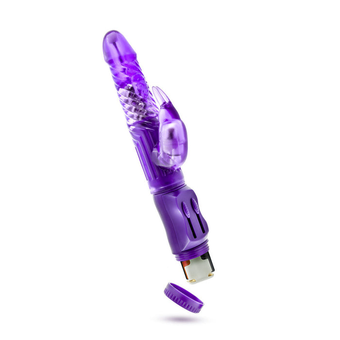 Introducing the B Yours Beginner Bunny Rabbit Vibrator by Blush, a perfect choice for those new to personal vibrators. Available in various colors including purple, this sleek device features multiple vibration settings. It boasts a rounded, textured shaft with rotating beads and a smaller rabbit-shaped clitoral stimulator. The base easily unscrews to reveal the battery compartment, ensuring smooth and hassle-free use.