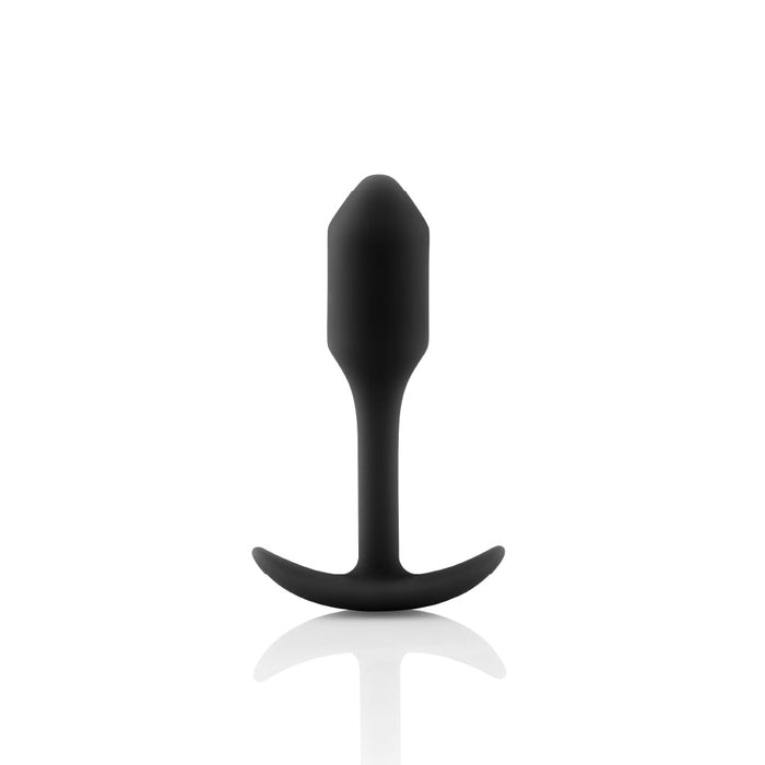 A black B-vibe Snug Plug 1 Weighted Silicone Butt Plug boasting a silky, tapered design with a flared base is showcased against a plain white background. This waterproof b-Vibe product, weighing in at 2 oz, is engineered for safe and comfortable use.