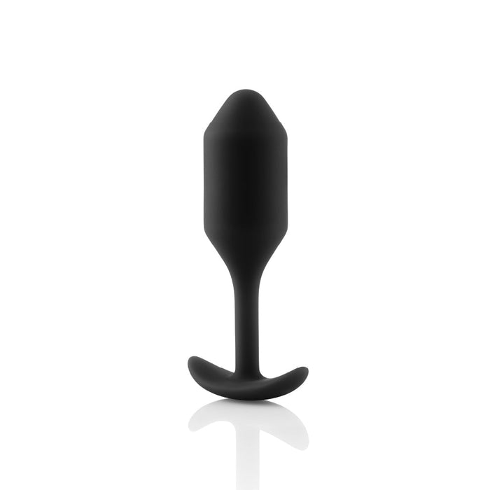 The B-vibe Snug Plug 2 Weighted Silicone Butt Plug in black, crafted by b-Vibe, features a tapered tip and flared base for comfortable insertion and easy removal. Set against a white backdrop, this 5 oz plug’s smooth texture and ergonomic shape are prominently highlighted.