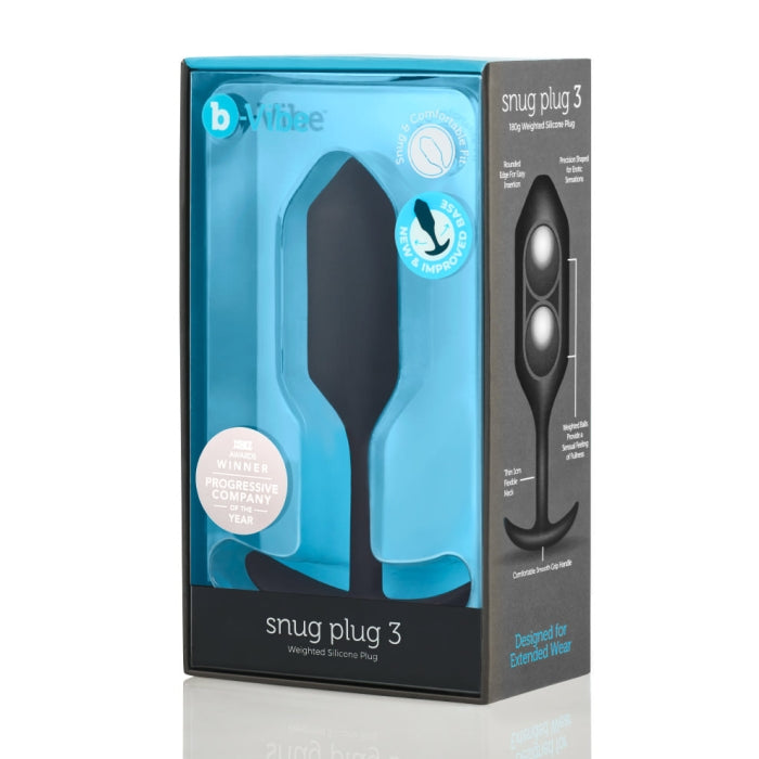 A product image of the B-vibe Snug Plug 3 Weighted Silicone Butt Plug - 6 oz - Various Colors, in its original packaging. The predominantly black box with a clear front showcases the toy, highlighting its accolades and design for extended wear as a versatile, waterproof anal toy.