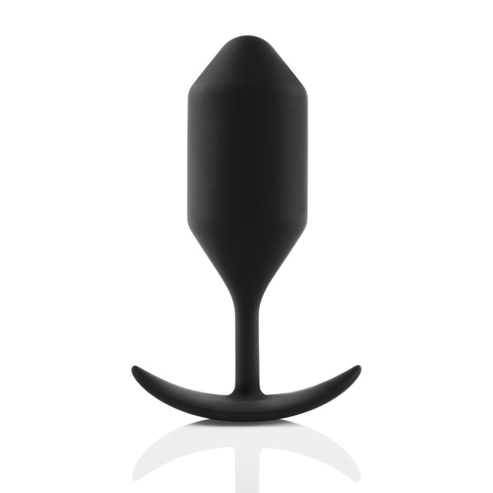 The B-vibe Snug Plug 4 XL Weighted Silicone Butt Plug (9 oz) in black, by b-Vibe, is designed for anal play with a tapered and smooth design, featuring a narrow neck and a curved base. Positioned upright against a plain white background, this snug plug offers the perfect balance of comfort and stimulation.