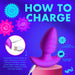 Infographic on how to charge the BANG! Rotating & Vibrating Silicone Butt Plug with Remote by XR Brands. The image depicts the silky-smooth silicone butt plug connected to a USB cable and notes a 2-hour charging time for 50 minutes of run time. The text emphasizes versatility, ease of charging, and the importance of removing it from the charger once fully charged.