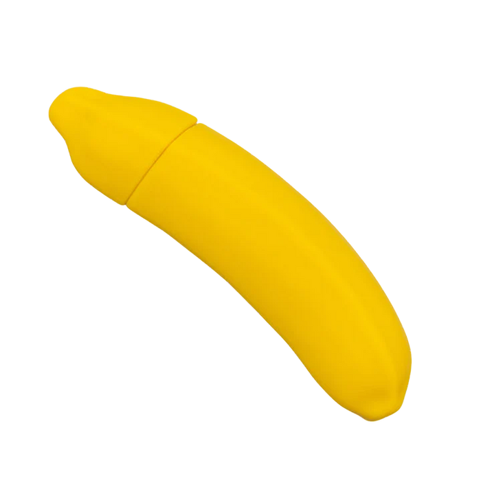 A Banana Emojibator Ultra Discreet First Time Bullet Vibrator from Dame Products, designed with a bright yellow, banana-shaped silicone case featuring a top seam for opening. The closed case mimics the texture of a real banana peel.