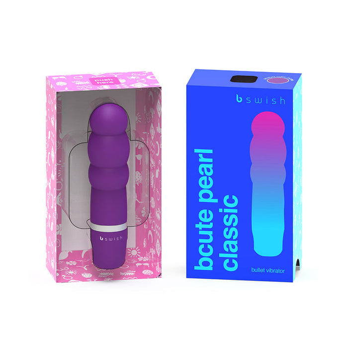 Three purple bullet vibrators are shown in their packaging. One is displayed in a pink floral-patterned box with a clear front, while another is showcased in a blue and purple gradient box with the text "Bcute Classic Beginner Pearl Vibrator - Purple" by bSwish on the front, ideal for clitoral stimulation.