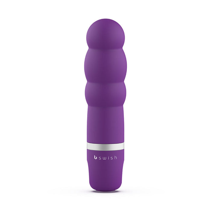 A purple, multi-textured personal massager with a smooth, bulbous design and a silver ring near the base. The brand name "bSwish" is printed on the lower portion of the waterproof Bcute Classic Beginner Pearl Vibrator - Purple.