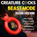 Image of a promotional poster for the "Beast Mode Fantasy Cock Ring" by XR Brands. The poster showcases a red, stretchy silicone ring adorned with horn-like designs. The text emphasizes the dominance and tenacity of the Beast Mode c-ring, noting that it "refuses to let go" for an intense climax.