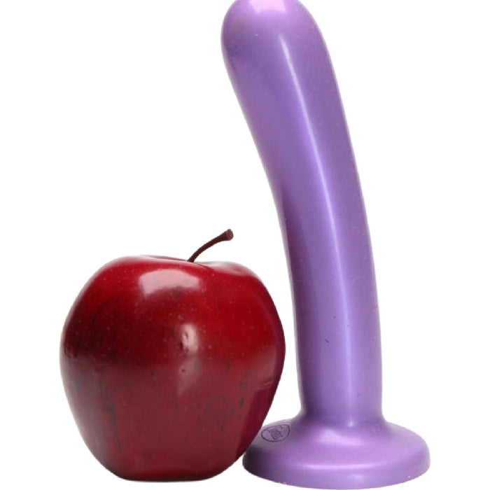 A red apple standing next to a purple Tantus Bend Over Intermediate 2 Dildos + Vibrating Strap-on Harness with a curved shape on a white background.