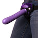 A person wearing jeans with a purple Tantus Bend Over Intermediate 2 Dildos + Vibrating Strap-on Harness handle sticking out of the pocket, resembling a tool or fashion accessory.