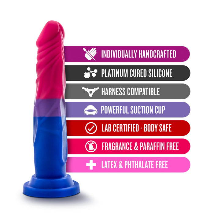 Image of the Bisexual Pride 7.5 Inch Silicone Suction Cup Dildo by Blush, featuring a blue and pink color scheme that resembles the bisexual flag and a flared base. Adjacent features include: "Individually Handcrafted," "Platinum Cured Silicone," "Harness Compatible," "Powerful Suction Cup Dildo," "Lab Certified - Body Safe," "Fragrance & Paraffin Free," and "Latex & Phthalate Free.