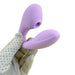 A gloved hand holding the Blaze Air Pulsation and G-Spot Bendable Double Ended Vibrator in a striking shade of purple by Nasstoys.