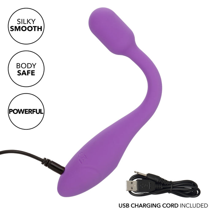 The Bliss Flex O Teaser Slim First Time G Spot Vibrator by CalExotics is a purple, curved vibrator with a bulbous end. It features a silky smooth, body-safe design and delivers powerful, intense vibrations for unmatched G-spot pleasure. The product includes a USB charging cord, which can be seen plugged into the base.