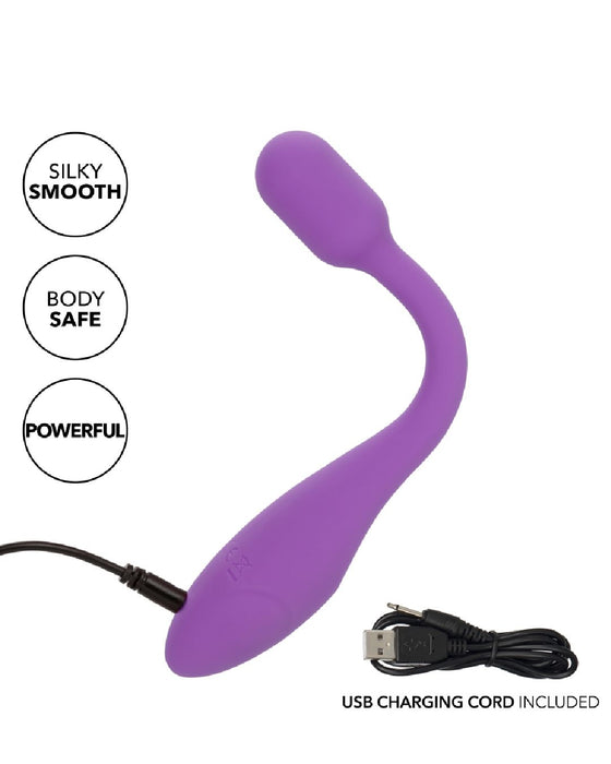 The image shows the Bliss Flex O Teaser Slim First Time G Spot Vibrator by CalExotics, featuring a purple, curved design with a bulbous tip. The product highlights "Silky Smooth," "Body Safe," and "Powerful" as key features. A black USB charging cord is connected to the vibrator and placed below it, accompanied by the text "USB Charging Cord Included." This waterproof toy delivers intense vibration for ultimate G-spot pleasure.