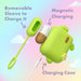 The Blooming Bliss First Time Bullet & Egg Vibrators with Charging Case & Remote by Blush is displayed in the image. The green charging case features a paw print design, and inside it, a small handheld device is inserted. Also shown is a removable sleeve for charging and a magnetic charging feature, with the subtle inclusion of the vibrating egg. A USB-C charging cable is visible at the bottom of the image against a pastel background.