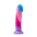 The Borealis Dreams 7.75 Inch Girthy Silicone Dildo - Cotton Candy by Blush is a multicolored silicone dildo featuring a gradient design that blends blue, pink, and purple hues. It has a realistic shape with a rounded head and a flared base for stability. Equipped with a powerful suction cup, it allows for hands-free fun on any flat surface. The smooth and soft surface enhances the overall experience.
