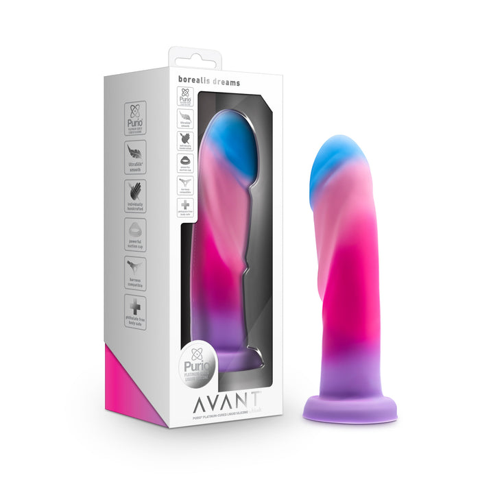 A silicone dildo with a suction cup base, showcasing a striking mix of blue, pink, and purple shades. Displayed both within its clear window packaging and individually. Specifically designed for prostate stimulation, the box highlights product features and is labeled "Borealis Dreams 7.75 Inch Girthy Silicone Dildo - Cotton Candy" by Blush.