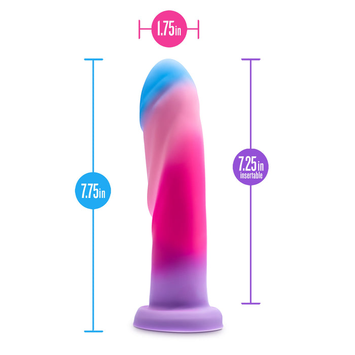 The Borealis Dreams 7.75 Inch Girthy Silicone Dildo - Cotton Candy by Blush is a multicolored toy featuring a blue, pink, and purple gradient. This dildo has a suction base and measures 7.75 inches in length with a diameter of 1.75 inches, providing 7.25 inches of insertable length. It's also compatible with strap-on harnesses for added versatility and fun.