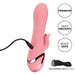 The California Dreaming Pasadena Player G-Spot Rabbit Vibrator by CalExotics, featuring a pink, textured silicone design, is connected to a USB charging cord. Accompanying text highlights "Premium," "Silky Smooth," and "Body Safe" qualities. The vibrator includes a clitoral arm for added pleasure, with the USB charging cord shown separately at the bottom right.