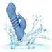 The California Dreaming Santa Cruz Coaster Thrusting G-Spot Rabbit Vibrator by CalExotics, featuring a blue silicone body with a ribbed shaft and two prongs, is partially submerged in water. Water splashes around the waterproof device, which is shown against a white background, making it perfect for clitoral stimulation.