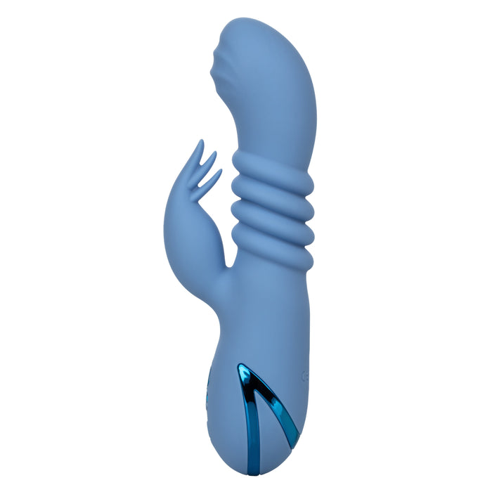 The California Dreaming Santa Cruz Coaster Thrusting G-Spot Rabbit Vibrator by CalExotics is displayed in blue silicone with a curved, textured head. It features a smaller protruding arm for enhanced clitoral stimulation, ribbed sections near the top, and waterproof capabilities. The handle area is adorned with metallic blue accents.