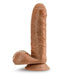 The Coverboy Derek the Bartender 7 Inch Uncut Dildo in Mocha from Blush features a realistic brown silicone design with detailed veins, a rounded head, and a body-safe suction cup base. Standing upright against a plain white background, it showcases its lifelike skin texture perfectly.