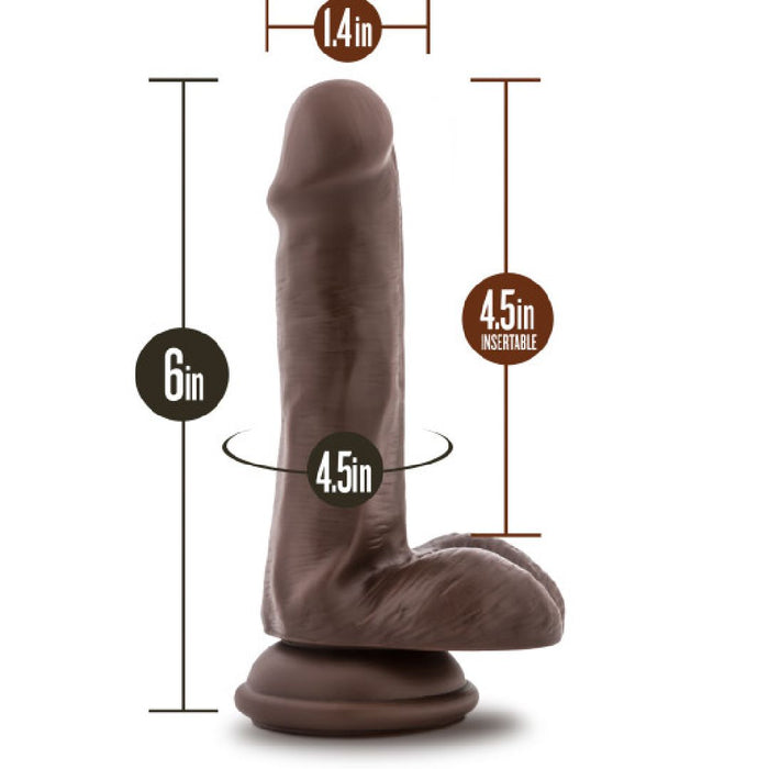 The Coverboy Top Gun Tommy 6 Inch Dildo by Blush in a rich chocolate hue boasts a realistic design and lifelike skin texture. It features a sturdy suction cup base for hands-free fun and is strap-on harness compatible for versatile play. Measurements: 6 inches total length, 4.5 inches insertable length, 1.4 inches diameter, and a circumference of 4.5 inches.