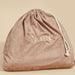 A soft, pinkish-brown drawstring bag with the word "Dame Products" embroidered on the front. The velvety material and white rope for the drawstring give it an elegant touch. Perfect for discreetly storing your intimate accessories, such as the Dame Pillo Sex Pillow for Sex Positioning - Indigo, against a beige background.