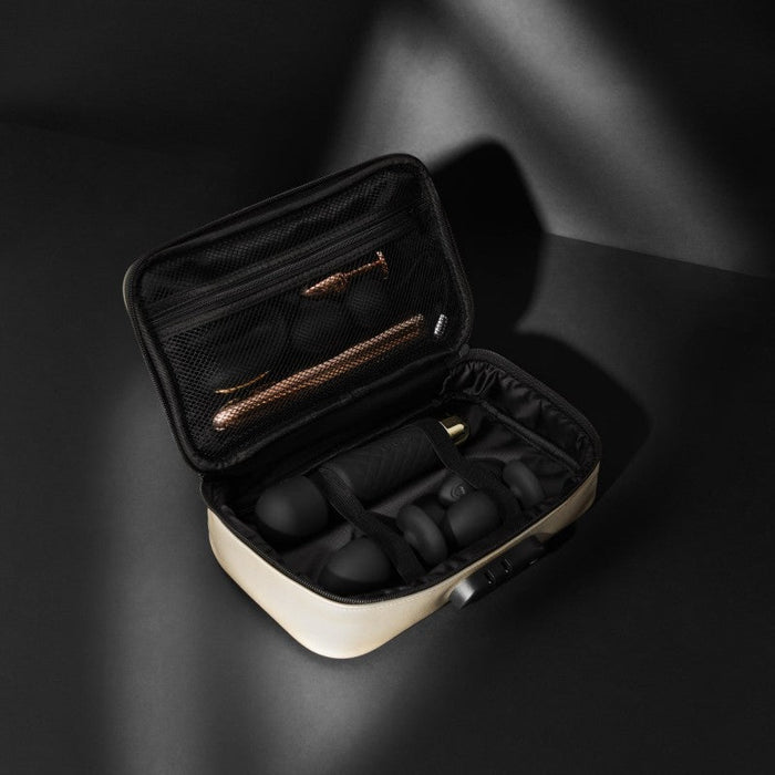 The Dorcel Lockable Discreet Gold Storage Box by Lovely Planet unveils a beige toiletry case with a black interior, showcasing an array of meticulously arranged grooming tools such as a shaver, clippers, and various black grooming components. The lid includes a mesh compartment that securely holds additional grooming accessories, making it the perfect discreet box for your essentials.