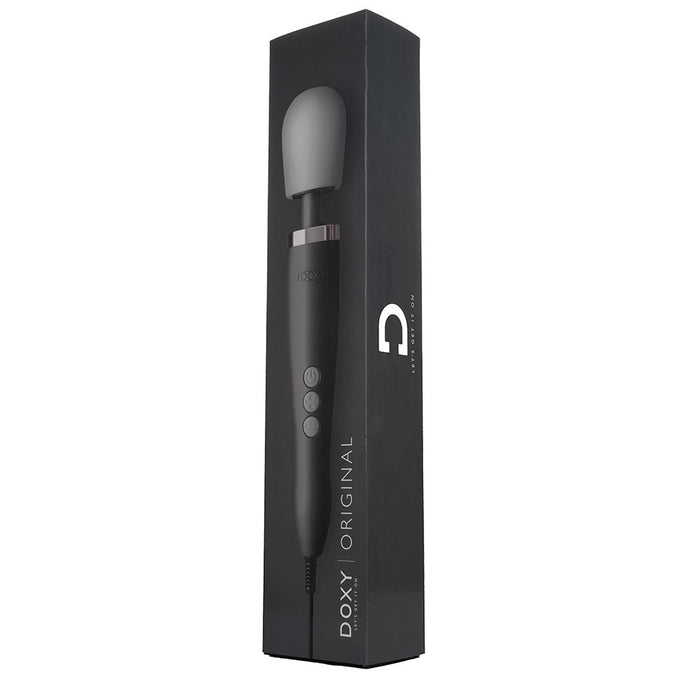 A Doxy Extra Powerful Wand Vibrator - Black, featuring a black and silver design with a bulbous head, is displayed standing upright next to its black and gray rectangular packaging labeled "DOXY | ORIGINAL." This wand, made from medical-quality silicone, includes control buttons on its handle for delivering powerful vibrations.