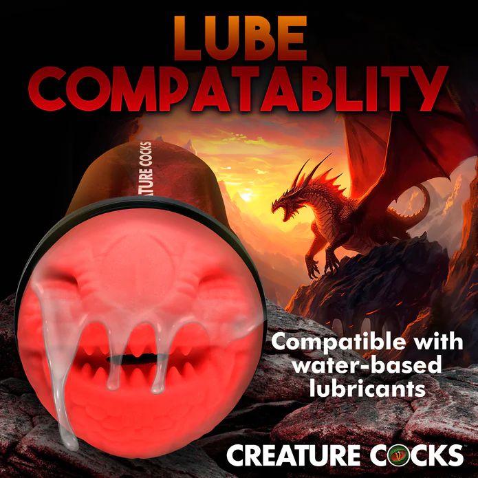 A red sculpture of a fantasy goat head is depicted near the text "Lube Compatibility" and "Compatible with water-based lubricants." In the background, XR Brands' Dragon Snatch Stroker Fantasy Role Play Stroker lies on a rocky landscape at sunset. The "Creature Cocks" logo is at the bottom, highlighting its unique textured ribs for added pleasure.