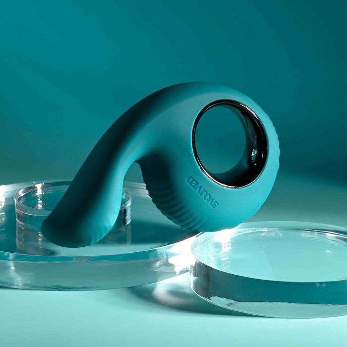 The Thumbs Up Shallow Penetration Vibrator, featuring a finger loop design, is elegantly displayed on transparent round platforms against a tranquil turquoise background.