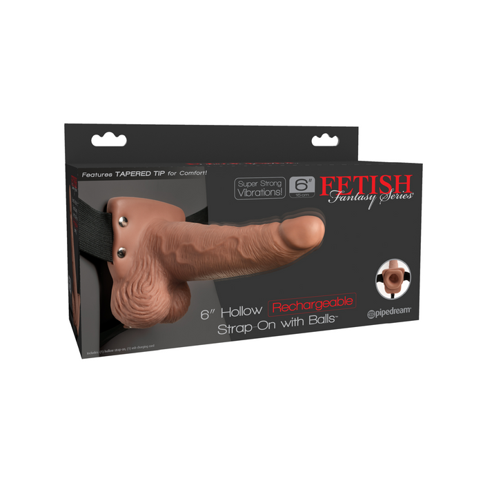 Packaging for the Fetish Fantasy Vibrating 6 Inch Hollow Dildo with Balls & Strap-on Harness in caramel shows the rechargeable toy with realistic veins, vibrations, and a tapered tip. The box includes an image of the product and branding details.