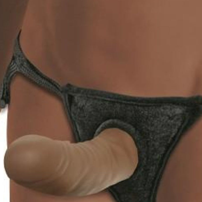 A close-up image of a person wearing a black harness with an Everlaster Wishbone 6.5 Inch Hollow Dildo & Strap-on Harness - Chocolate attached to the front. The realistic, beige-colored dildo features detailed veins, and the fabric harness fits snugly against the person's body. This product is by Sportsheets.