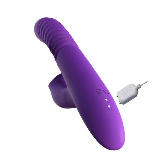 A Fantasy For Her Thrusting Warming Rabbit with Clitoral Stimulating Tongues by Pipedream Products, featuring a purple, curved design, textured grip, and wireless charging connector on a white background—ideal for those seeking clit stimulation.