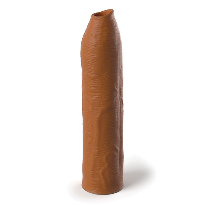 The Fantasy Uncut 7 Inch Silicone Penis Extension in Caramel from Pipedream Products, with its long, cylindrical shape, slightly curved tip, and textured surface resembling a silicone sleeve, stands upright on a light background.