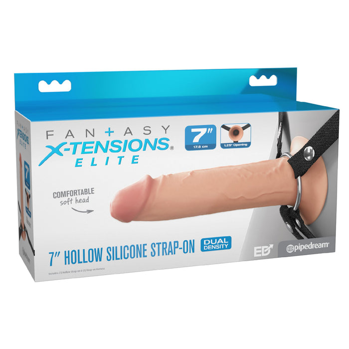 A product box for the "Fantasy X-Tensions Elite Hollow 7 Inch Silicone Dildo & Strap-On Harness - Vanilla" by Pipedream Products is shown. The mostly white box with blue accents showcases an image of the strap-on, highlighting its dual-density design and comfortable soft head—ideal for those experiencing erectile dysfunction.